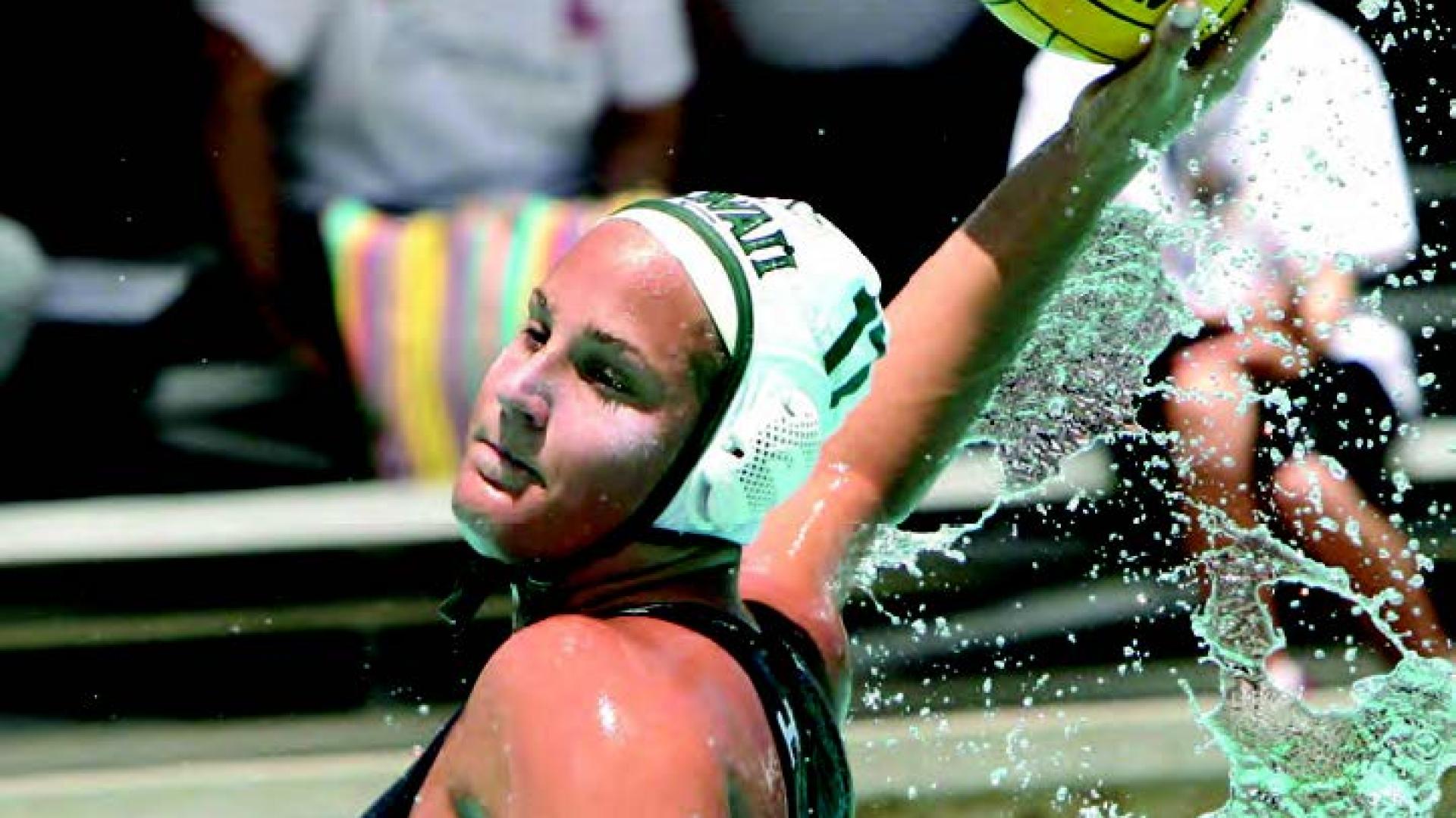 Carmen Eggens winds up to throw a watersport ball inside a pool.